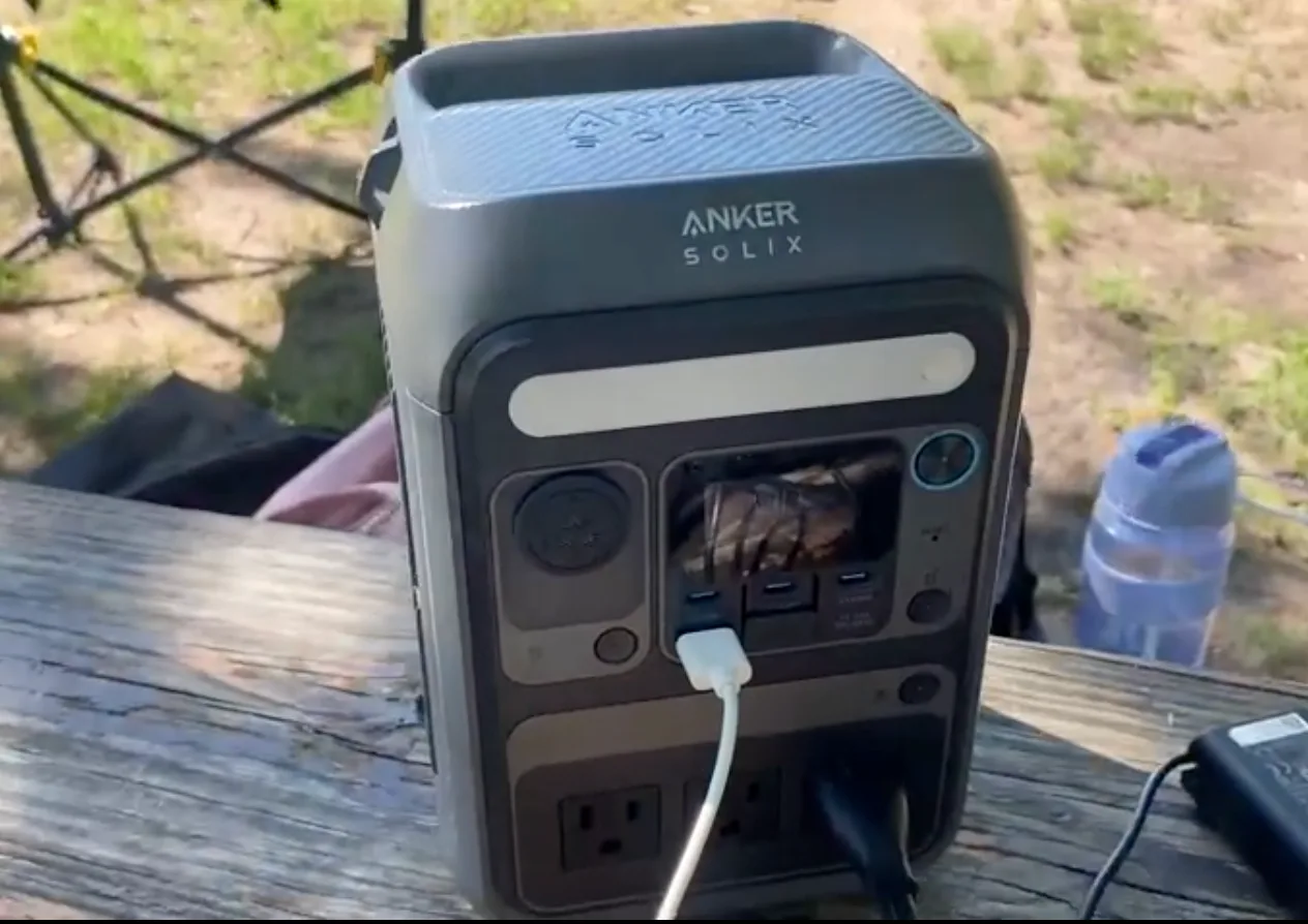 The C300 sits on a car seat, charging a phone and a camera battery on the way to a trailhead. At 9.1 lb, it's the one you actually carry.