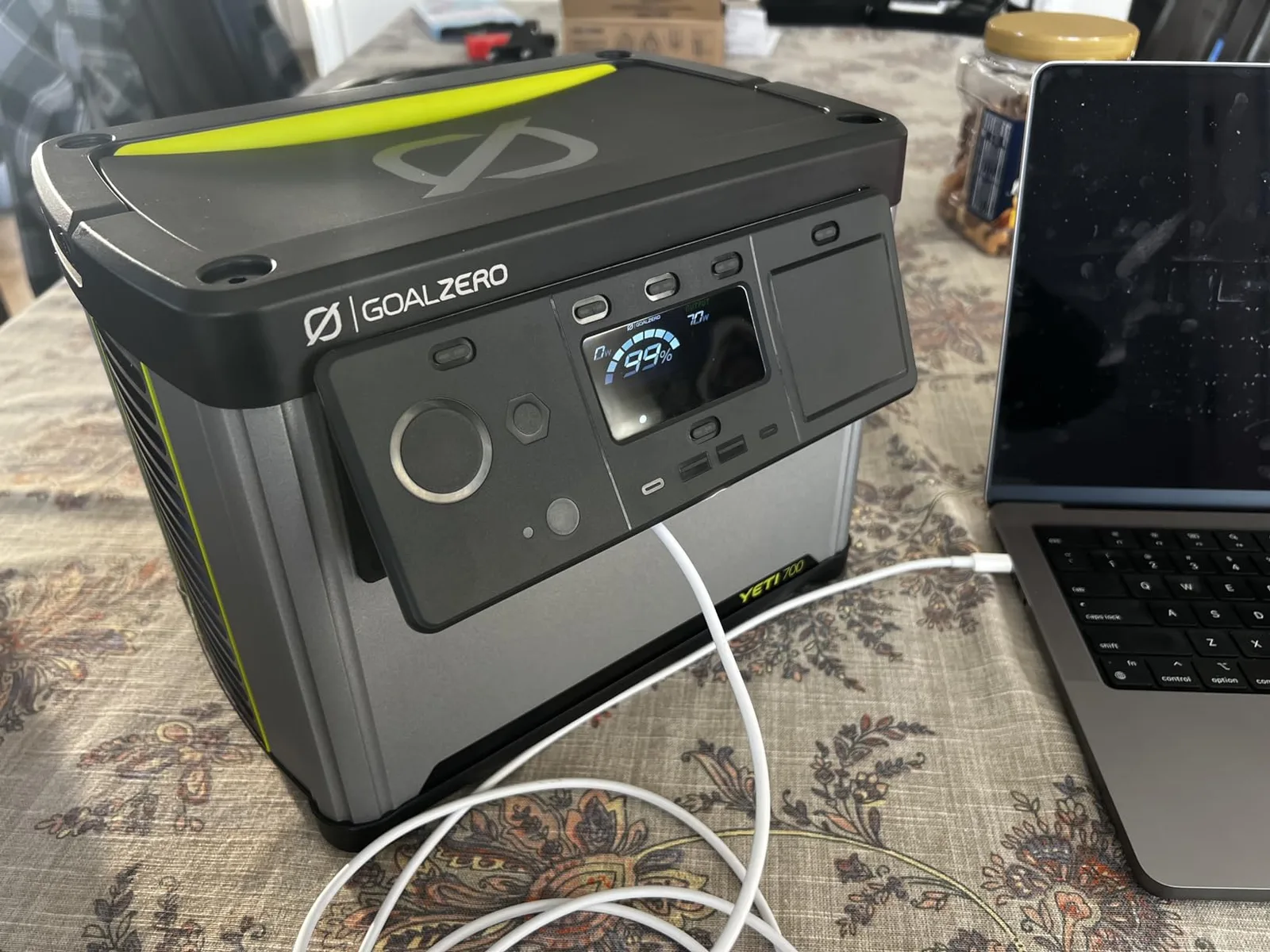 The Yeti 700 sits on a kitchen counter with a CPAP machine and a laptop plugged into its front ports during an evening power outage. At 20.3 lb, it's light enough to carry from room to room as needs change.